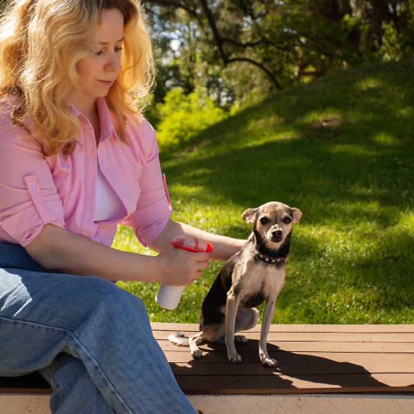 A woman with a dog sitting on a bench